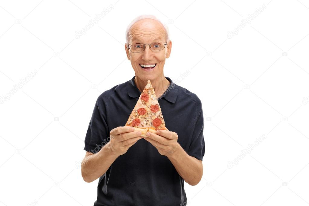 Cheerful elderly man holding a slice of pizza