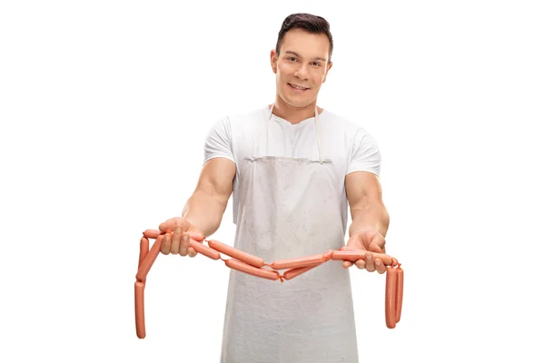 Butcher holding raw sausages — Stock Photo, Image