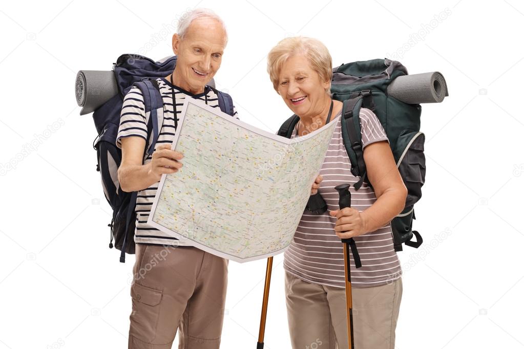 Elderly hikers looking at generic map