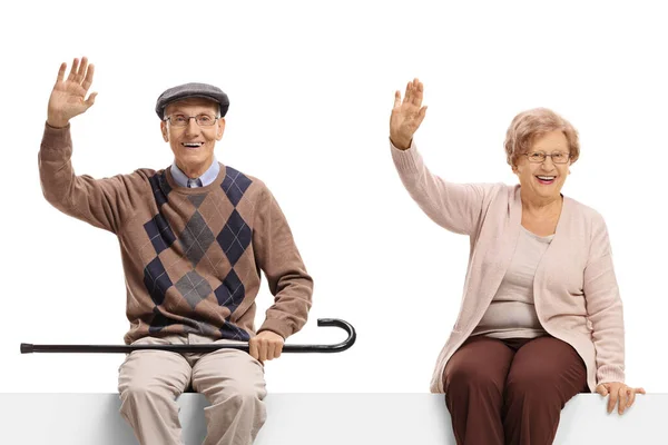 Elderly Couple Sitting Blank Billboard Sign Waving Camera Isolated White — Stock Photo, Image