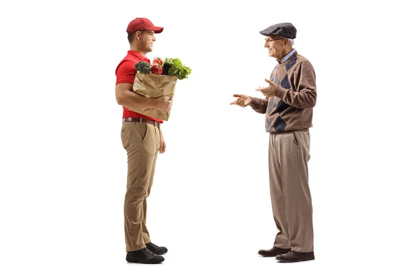 Full Length Profile Shot Delivery Man Holding Groceries Paper Bag — Stock Photo, Image