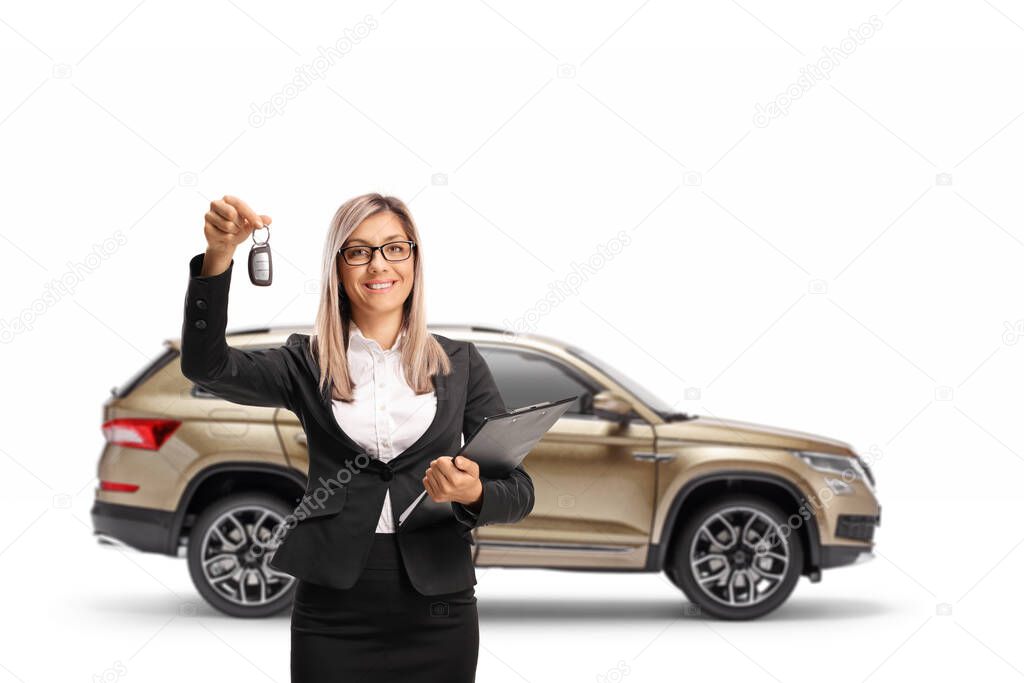 Businesswoman holding keys from a SUV isolated on white background