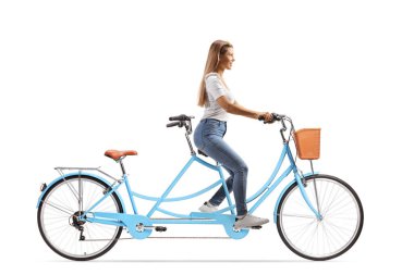 Uzun saçlı, mavi tandem bisiklete binen, beyaz arka planda izole edilmiş genç bir kadının tam boy profil çekimi.