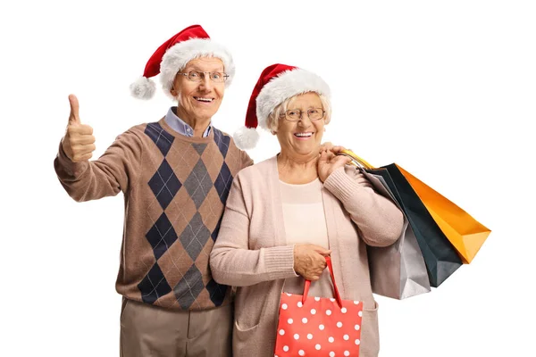 Ηλικιωμένο Ζευγάρι Τσάντες Χριστουγεννιάτικα Ψώνια Δείχνει Αντίχειρες Προς Πάνω Απομονώνονται — Φωτογραφία Αρχείου