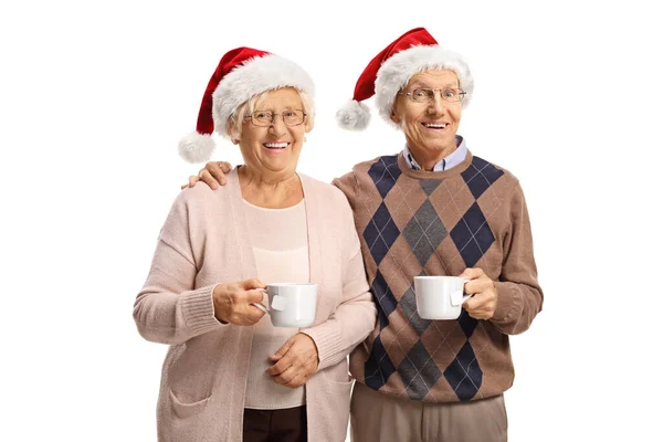 Elderly Couple Holding Tea Cups Wearing Santa Claus Hats Isolated — Stock Photo, Image