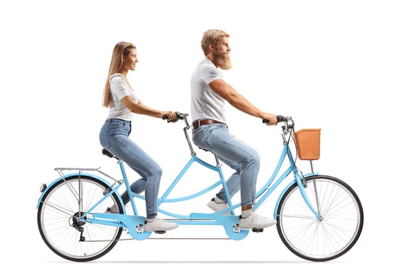 Young man and woman in white t-shirts and jeans riding a tandem bicycle isolated on white background