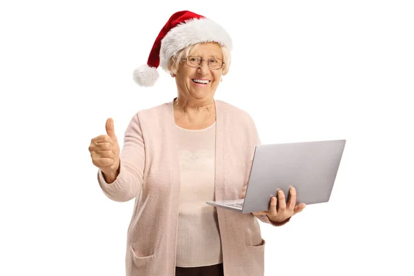 Happy Elderly Woman Holding Laptop Computer Wearing Santa Hat Showing — Stock Photo, Image