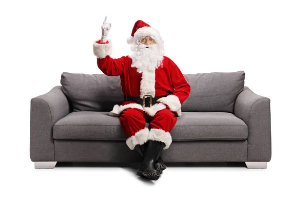 Santa Claus Sitting Gray Sofa Pointing Isolated White Background — Stock Photo, Image