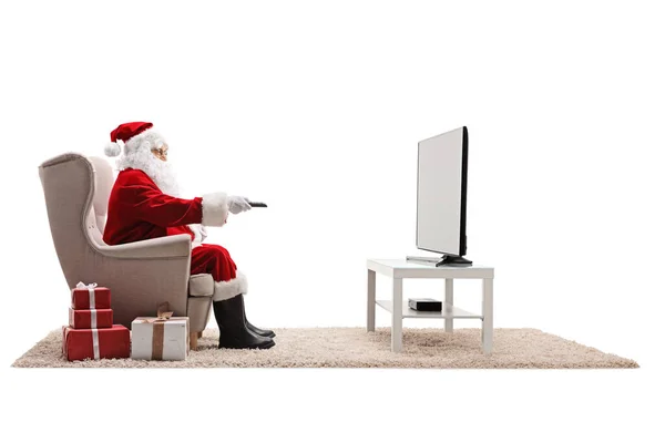 Full Length Profile Shot Santa Claus Armchair Τηλεχειριστήριο Βλέποντας Τηλεόραση — Φωτογραφία Αρχείου