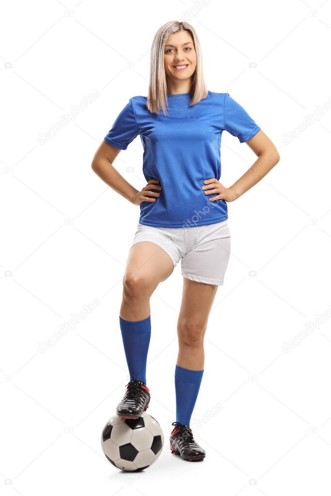 Full length portrait of a female football player posing with a soccer ball isolated on white background