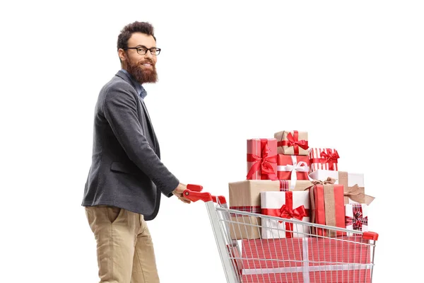 Uomo Barbuto Spingendo Carrello Pieno Regali Sorridendo Alla Fotocamera Isolata — Foto Stock