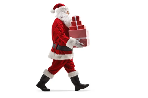 Full Length Profile Shot Santa Claus Walking Carrying Pile Christmas — Φωτογραφία Αρχείου