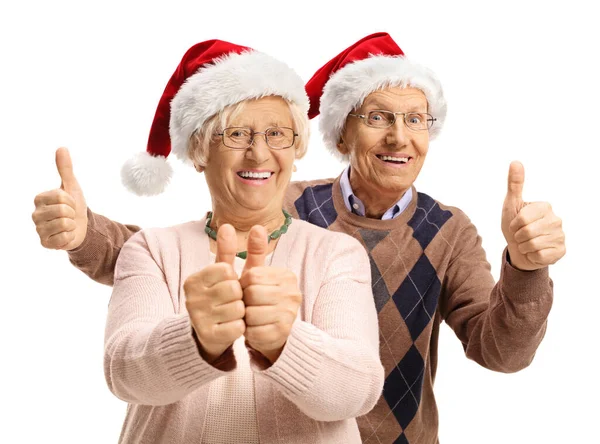 Szczęśliwa Para Starców Kapeluszami Świętego Mikołaja Trzymających Kciuki Górze Białym — Zdjęcie stockowe