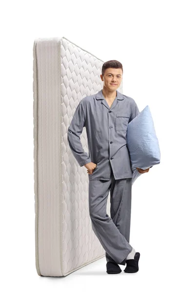 Full Length Portrait Young Man Pajamas Leaning Bed Mattress Holding — Stock Photo, Image