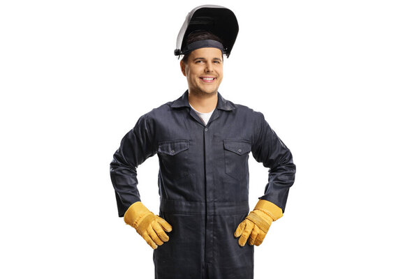 Smiling welder in a uniform with a protective helmet isolated on white background