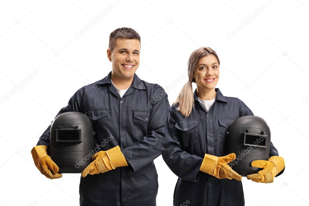 Team of a male and female welders in uniforms smiling at camera isolated on white background