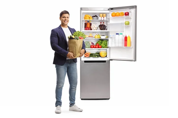 Young Man Grocery Bag Fridge Full Food Isolated White Background — Stock Photo, Image