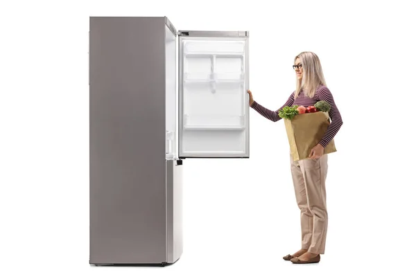 Young Woman Holding Bag Groceries Front Open Fridge Isolated White — Stock Photo, Image