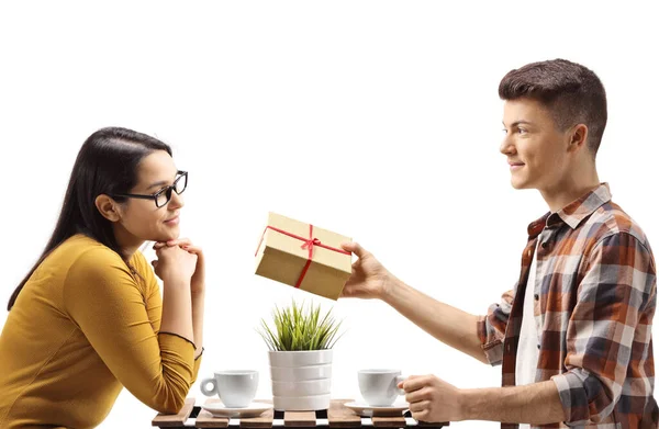 Boyfriend in a cafe giving a present to a girlfriend isolated on white background