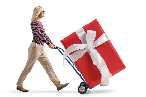 Full Length Profile Shot Young Woman Walking Pushing Hand Truck — Zdjęcie stockowe