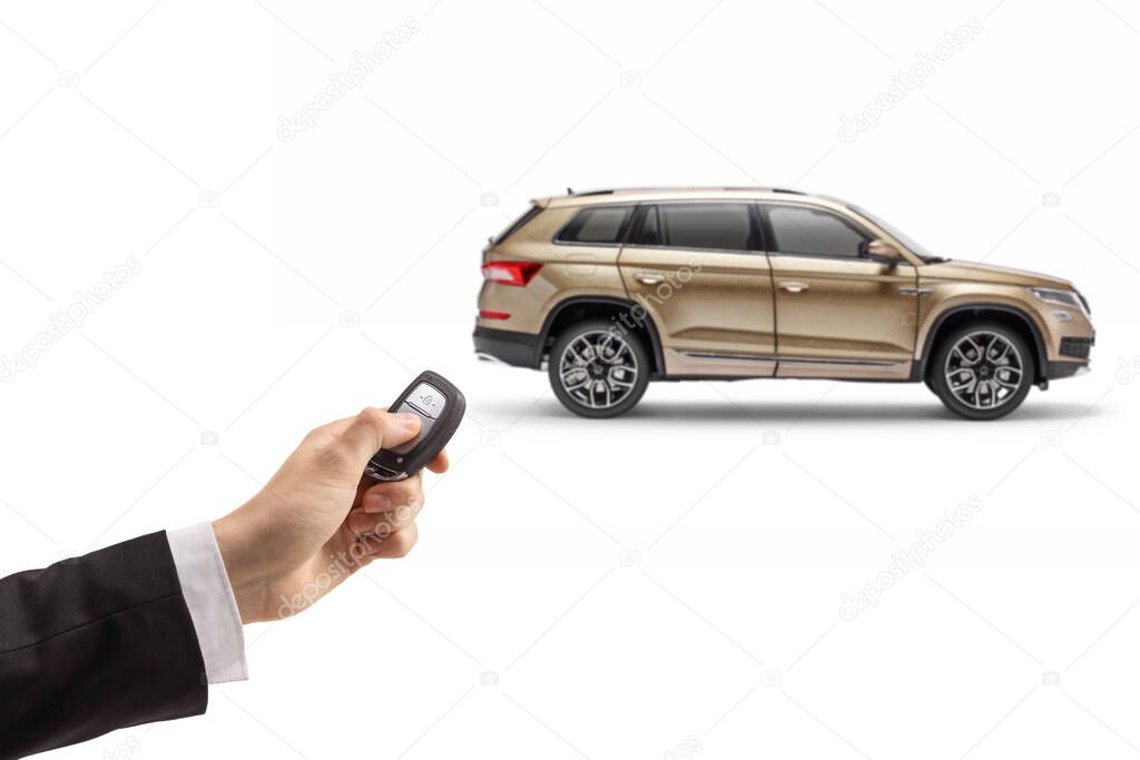 Male hand in a suit unlocking a SUV with a remote key isolated on white background
