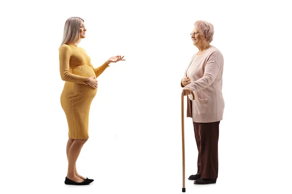 Full Length Profile Shot Pregnant Woman Talking Elderly Woman Isolated — Stock Photo, Image