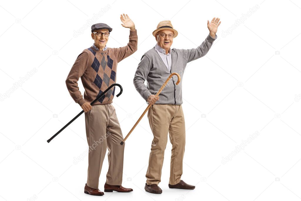 Cheerful elderly men with walking canes waving at the camera isolated on white background