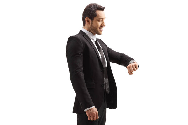 Man in a suit checking his watch isolated on white background