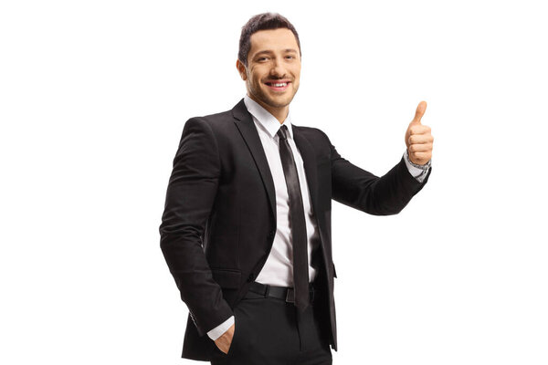 Smiling man in a black suit showing thumbs up isolated on white background