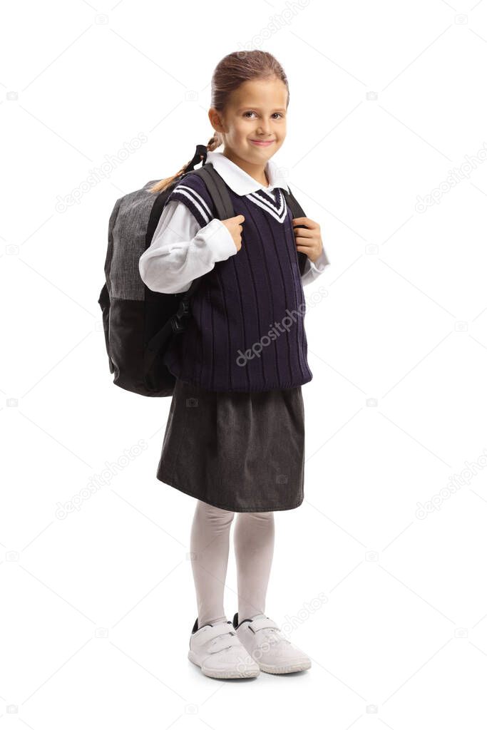 Full length portrait of a smiling schoolgirl in a uniform isolated on white background
