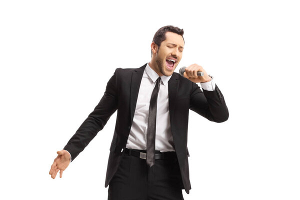 Singer in a suit singing on a microphone isolated on white background