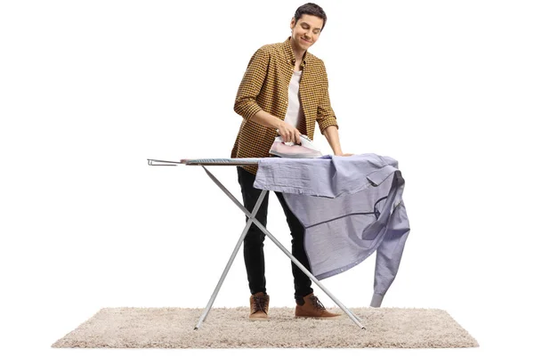 Joven Alegre Planchando Una Camisa Aislada Sobre Fondo Blanco —  Fotos de Stock