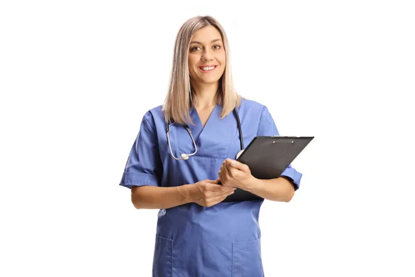 Female Health Care Worker Blue Uniform Holding Clipboard Isolated White — Stock Photo, Image