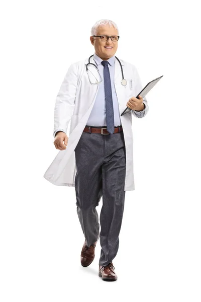 Full Length Portrait Mature Doctor Walking Camera Holding Clipboard Isolated — Stock Photo, Image