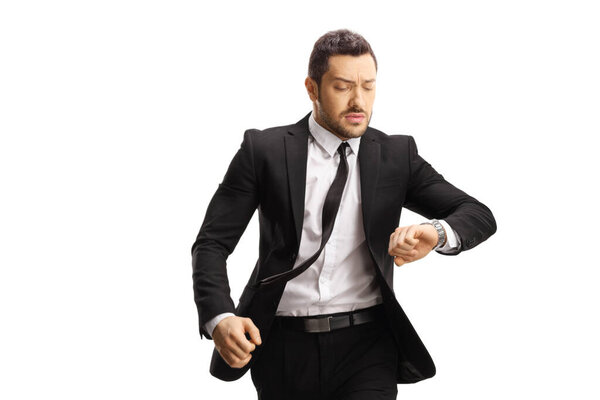 Serious young businessman running late isolated on white background