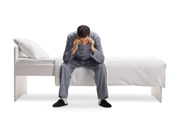 Man Pajamas Sitting Single Bed Holding His Head Isolated White — Stock Photo, Image