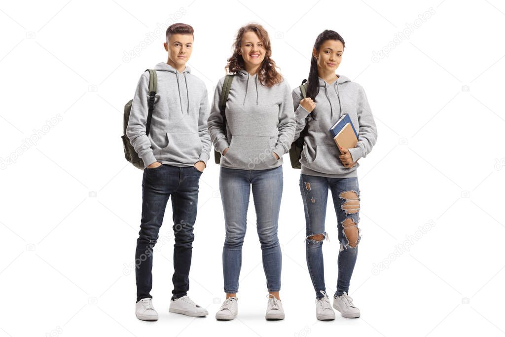 Full length portrait of a group of students wearing hoodies isolated on white background