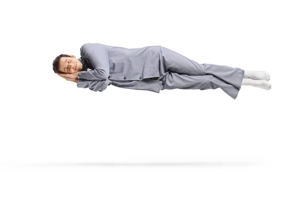 Slapende Man Pyjama Drijvend Lucht Geïsoleerd Witte Achtergrond — Stockfoto