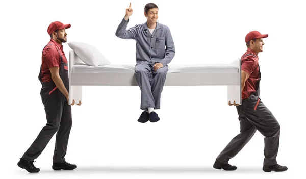 Movers Carrying Single Bed Man Pajamas Sitting Pointing Isolated White — Stock Photo, Image