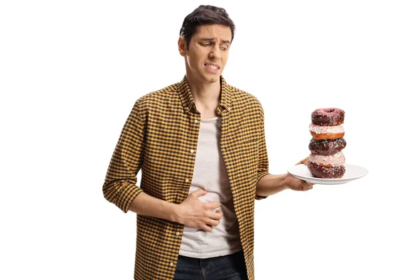 Junger Mann Mit Bauchschmerzen Hält Einen Teller Donuts Auf Weißem — Stockfoto