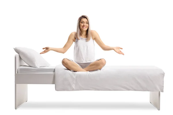 Smiling Young Woman Pajamas Sitting Bed Gesturing Hands Isolated White — Stok Foto