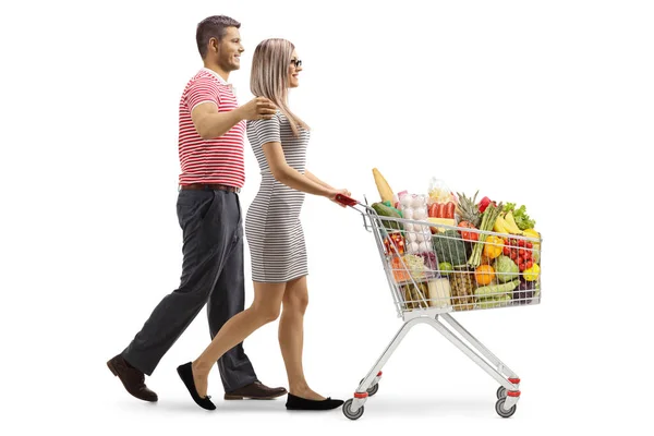 Perfil Jovem Casal Empurrando Carrinho Compras Isolado Fundo Branco — Fotografia de Stock