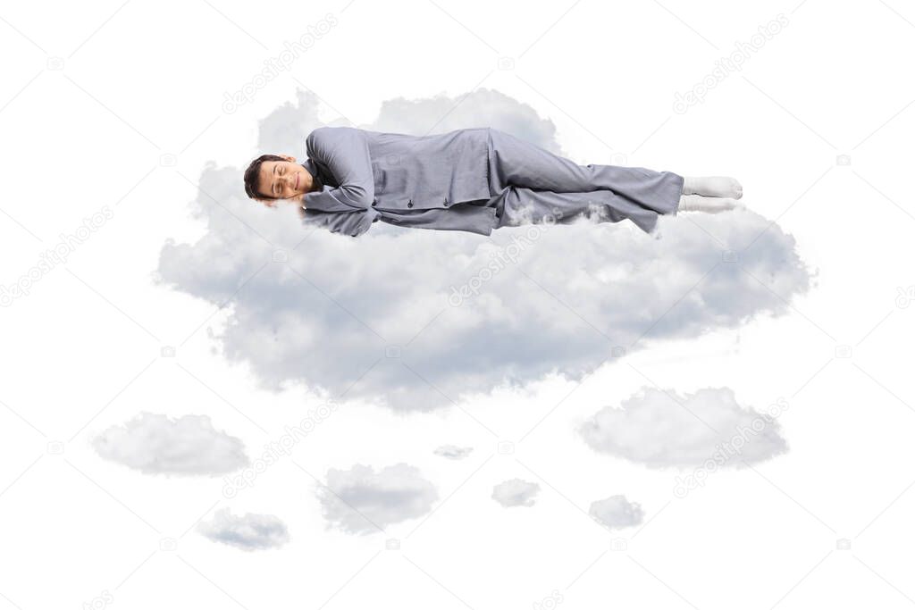 Young man in pajamas floating in the air and sleeping on clouds isolated on white background