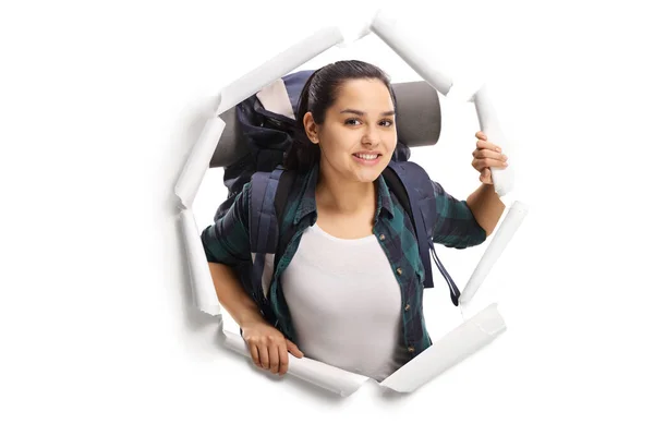 Female Backpacker Peeking Paper Hole Isolated White Background — Stock Photo, Image