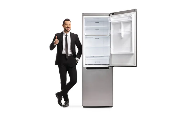Full Length Portrait Young Businessman Leaning Empty Fridge Gesturing Thumbs — Stock Photo, Image