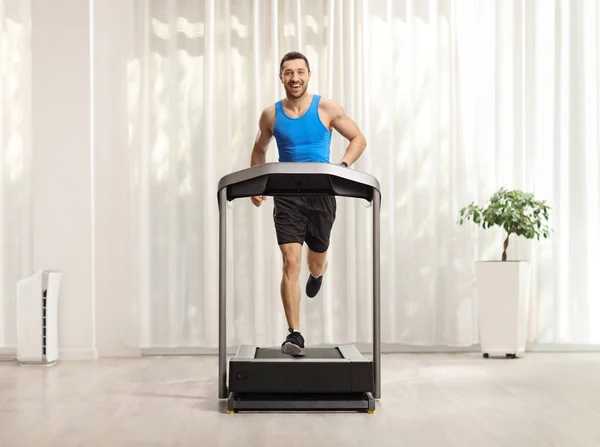 Full Length Portrait Fit Young Man Running Treradmill Room Gordtain — Stockfoto