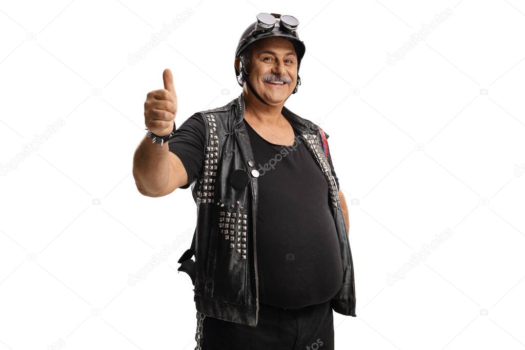Mature biker with a leather vest and a helmet gesturing a thumb up isolated on white background