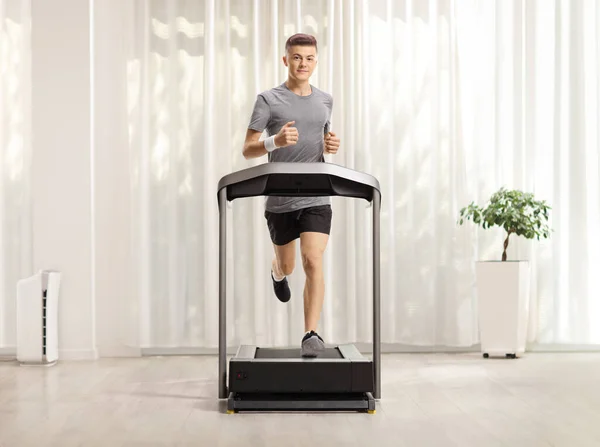 Full Length Portrait Young Man Exercising Treadmill Room Curtain — Stock Photo, Image