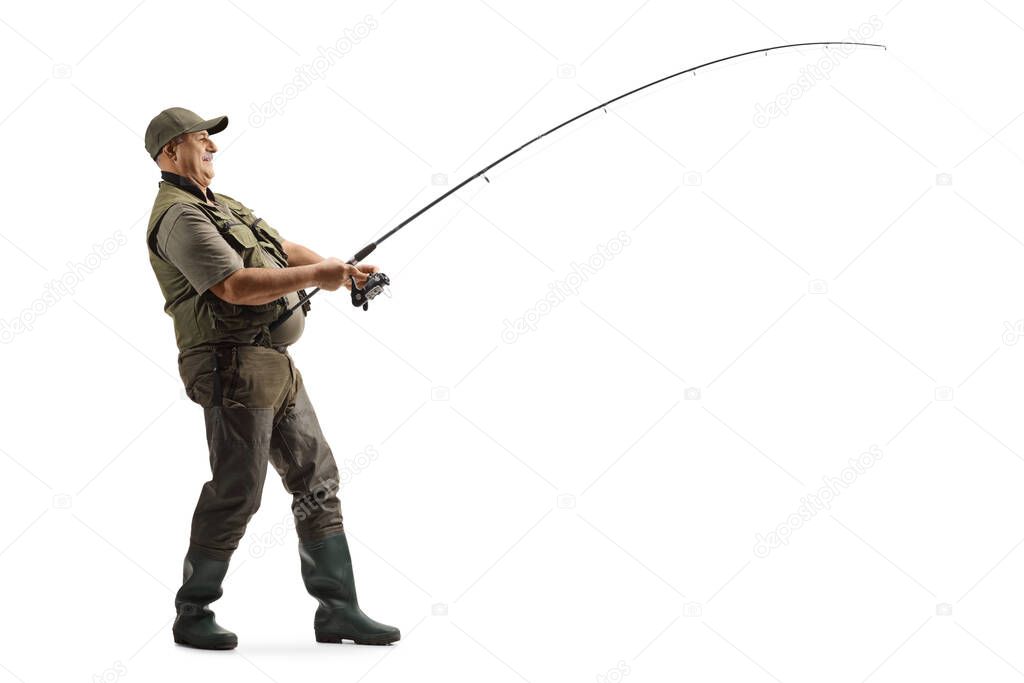Full length profile shot of a mature fisherman in a uniform fishing isolated on white background