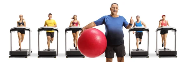 Mature Man Fitness Ball Showing Thumbs Gym Treadmills People Running — Stock Photo, Image